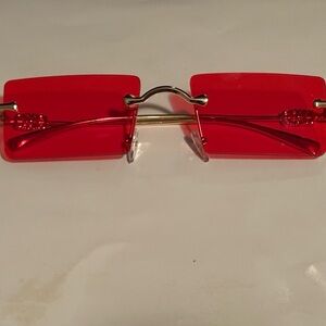 Chic Red Rimless Sunglasses with Gold Details